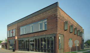 Gentry Public Library exterior photo of brick textures, metal, and glass encase window openings