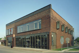 Gentry Public Library exterior photo of brick textures, metal, and glass encase window openings
