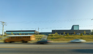 The building's new cohesive exterior face seen from MLK boulevard to the south amidst busy traffic from cars and busses