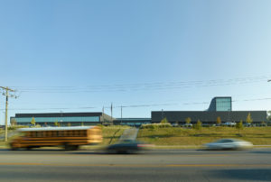 The building's new cohesive exterior face seen from MLK boulevard to the south amidst busy traffic from cars and busses