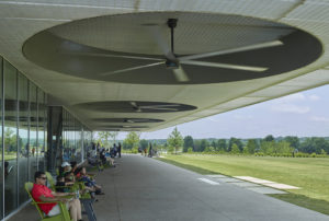 The landscape and shaded 'porch' with large fans give gathering families a spot to cool off in the heat of the summer