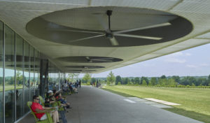 The landscape and shaded 'porch' with large fans give gathering families a spot to cool off in the heat of the summer