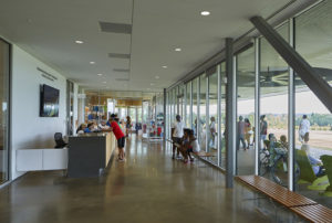 Interior shot of the center's reception and large glass windows as visitors explore the grounds