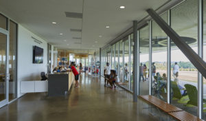 Interior shot of the center's reception and large glass windows as visitors explore the grounds