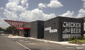 Back of the drive-through with painted walls reading 'Chicken and Beet get it to Go Here'