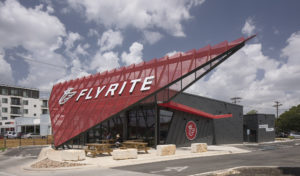 Exterior photograph of a Flyrite location with two people sitting at a table