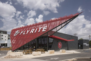 Exterior photograph of a Flyrite location with two people sitting at a table