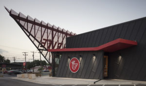 Metal building with large mounted chicken logo