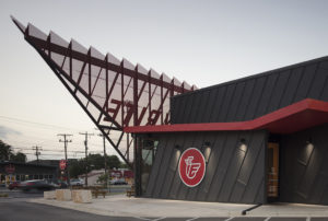 Metal building with large mounted chicken logo