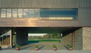 The underbelly of the structure opening to the green golf course beyond