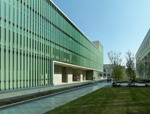 A sprawling shot of fritted glass walls and limestone along the exterior of the Design Center