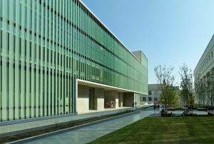 A sprawling shot of fritted glass walls and limestone along the exterior of the Design Center