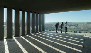 The top floor concrete and glass balcony looks down on the University campus and the city of Fayetteville beyond