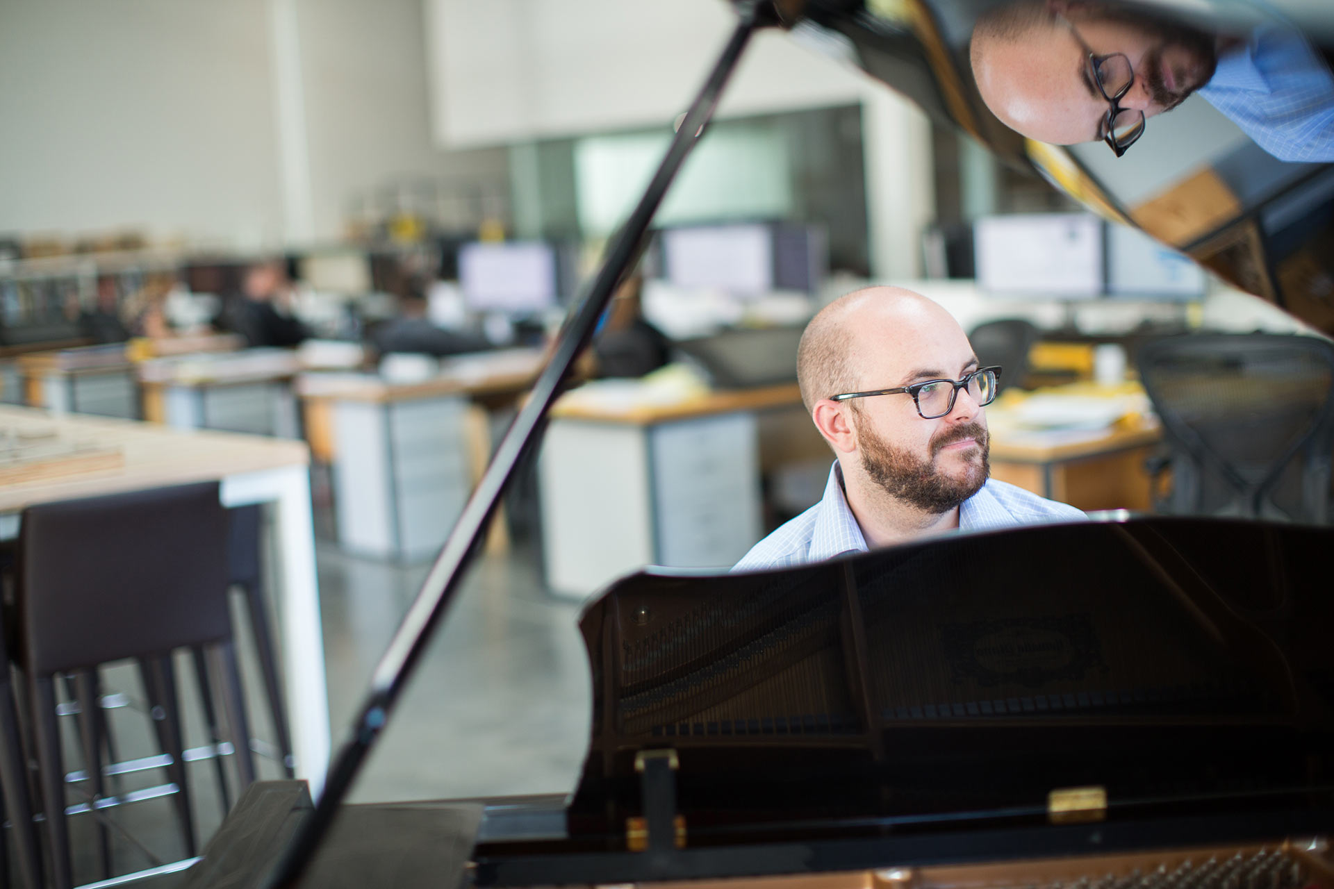 Photograph of Stephen Reyenga playing piano in the studio