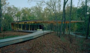 Indianapolis Museum of Art Visitors Pavilion seen in profile deep in the woods