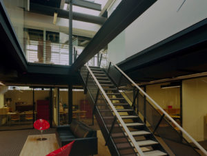 Beautiful wood, glass, and steel beams make up the interior which is lit by skylight above