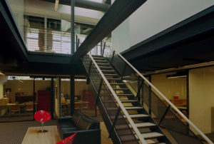 Beautiful wood, glass, and steel beams make up the interior which is lit by skylight above