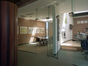 Brick and glass office spaces with natural light from skylights above