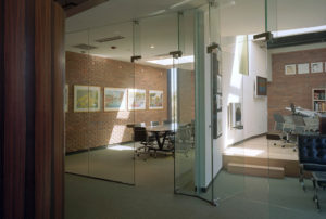 Brick and glass office spaces with natural light from skylights above