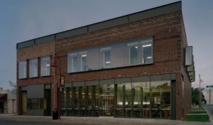 A stark view of the building's exterior facing Main St. at dusk