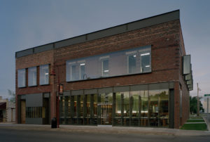 A stark view of the building's exterior facing Main St. at dusk
