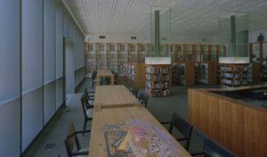 A view of the historic ceiling paired with the revitalized shelving and furniture