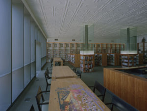 A view of the historic ceiling paired with the revitalized shelving and furniture