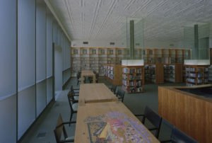 A view of the historic ceiling paired with the revitalized shelving and furniture