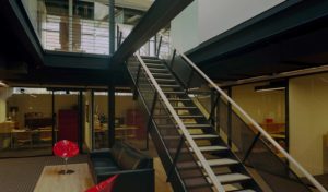 Beautiful wood, glass, and steel beams make up the interior which is lit by skylight above