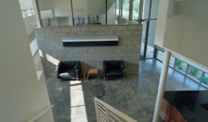 The Srygley Office Building interior showing concrete blocks and bright white walls above polish concrete floors decorated with modern office furniture