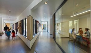 Angled hallways feeding into classrooms as children walk to class