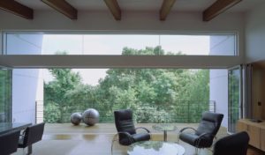 The Srygley Office Building interior shot of chairs, a table, and a railed balcony in a white airy environment