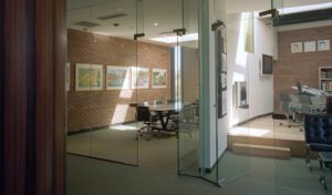 Brick and glass office spaces with natural light from skylights above