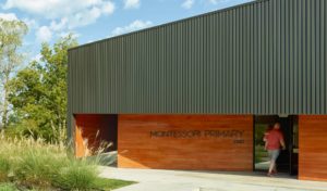Montessori Primary school exterior with box rib metal wall panels and cypress siding
