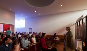 A church service under the dome of the St. Nicholas Eastern Orthodox Church