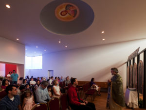 A church service under the dome of the St. Nicholas Eastern Orthodox Church