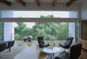 The Srygley Office Building interior shot of chairs, a table, and a railed balcony in a white airy environment