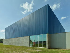 Exterior with blue metal roof and concrete block walls