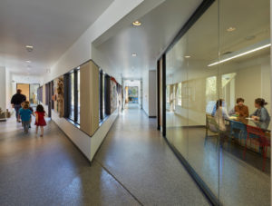 Angled hallways feeding into classrooms as children walk to class