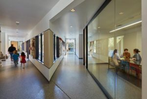 Angled hallways feeding into classrooms as children walk to class