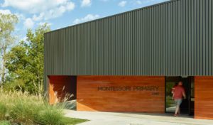 Montessori Primary school exterior with box rib metal wall panels and cypress siding