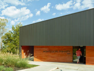 Montessori Primary school exterior with box rib metal wall panels and cypress siding