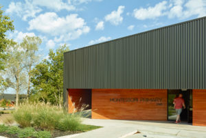 Montessori Primary school exterior with box rib metal wall panels and cypress siding