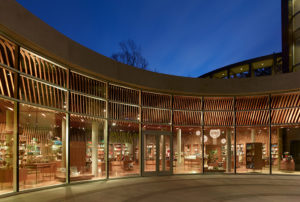 Crystal Bridges Museum Store exterior seen at night while being well-lit through large glass windows