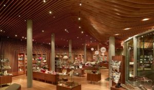 Crystal Bridges Museum Store wooden ribbed ceiling adorn with modern light fixtures hangs above the beautiful shop filled with gifts