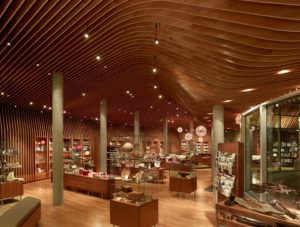 Crystal Bridges Museum Store wooden ribbed ceiling adorn with modern light fixtures hangs above the beautiful shop filled with gifts