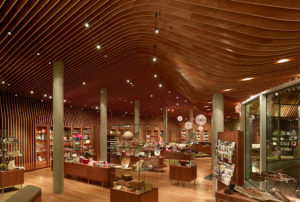 Crystal Bridges Museum Store wooden ribbed ceiling adorn with modern light fixtures hangs above the beautiful shop filled with gifts