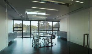 A conference room with glass windows and doors in the Northwest Arkansas Free Health Center