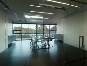 A conference room with glass windows and doors in the Northwest Arkansas Free Health Center