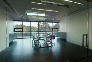 A conference room with glass windows and doors in the Northwest Arkansas Free Health Center